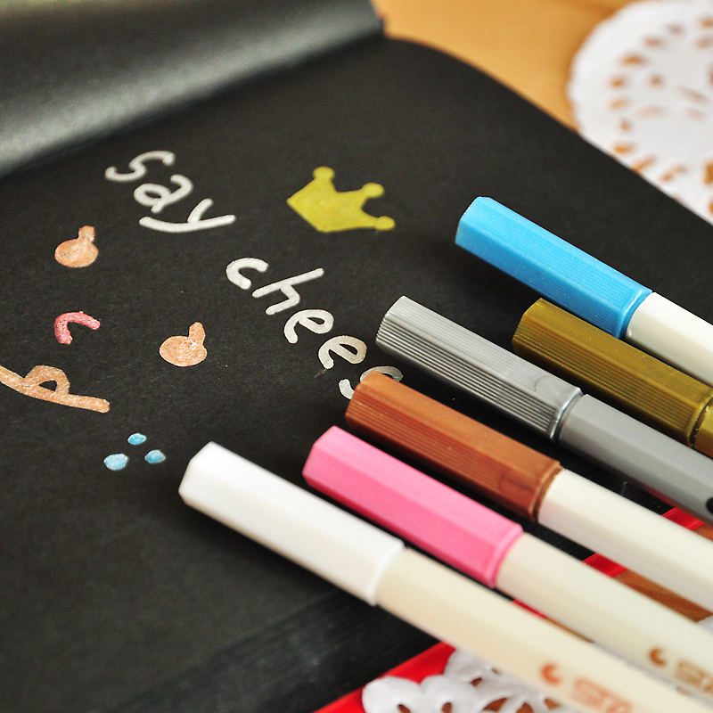 Markers that write on black paper