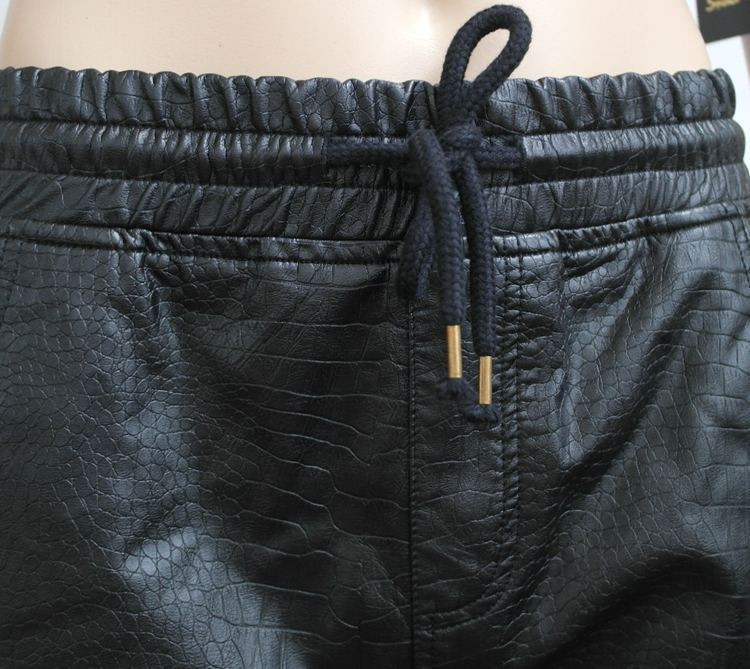 black leather joggers with gold zippers